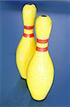 Bowling in yellow color still life blue background image