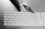 Futuristic silver gray hand and computer keyboard