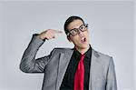 Businessman crazy with funny glasses and suit on gray background
