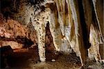 A collection of massive stalactites growing down from the ceiling in Carlsbad Caverns