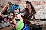 Young all girl punk rock band performs in a warehouse