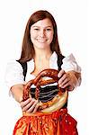 Portrait of young woman with Bavarian Dirndl dress holds Oktoberfest Pretzel. Isolated on white.