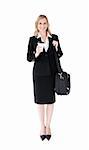 Smiling blond businesswoman holding coffee and a briefcase against white background