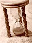 Hourglass in sand, shallow depth of field