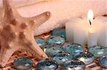 bath towels, candle, starfish and glass pebbles