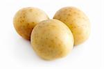 Three potatoes isolated on a white background.