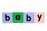 assorted childrens toy letter building blocks against a white background that spell baby with clipping path