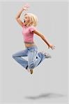 Dancing woman with blond hair and happy smiling facial expression jumping up. Studio isolated on white background with clipping path (hair it's not path).