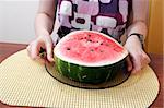 Young woman eating a slice of watermelon.