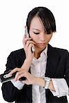 Busy business woman holding cellphones and watching watch, closeup portrait on white background.