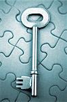 Single key resting on jigsaw puzzle