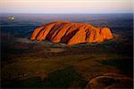 Uluru./ Orange Uluru in bright beams of the sunset sun. Aerial photography.