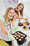Laughing woman baking together in the kitchen
