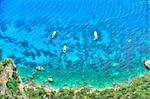 Yachts off the island of Capri and processed to appear as if they were in a painting.