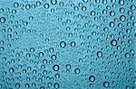 Blue water drops on glass window