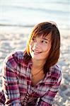 Portrait of beautiful brunet girl. Beach photo.