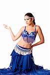 Beautiful Israeli Egyptian Lebanese Middle Eastern fashion belly dancer performer in blue skirt and bra sitting on knees, isolated.