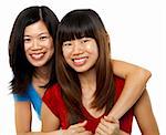 Two Asian sisters isolated on white background