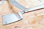 Stainless kitchen utensil on cutting table