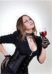 Gorgeous woman with red wine, studio shot