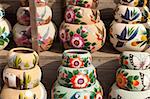 Variety of Colorfully Painted Ceramic Pots in an Outdoor Shopping Market.