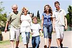 Extended family group walking down the pathway and looking at camera