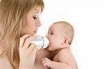 Mother give drink her baby boy by feeding bottle over white