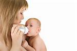 Mommy give drink her baby boy by feeding bottle over white