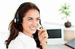 Smiling woman with headset working in a call center against a white background