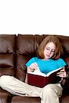 A beautiful young teenager reading a book