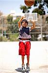 Young basketball player jumping high in air