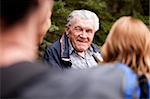 A grandfather talking a group of grandchildren