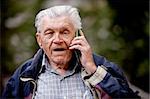 A senior talking on a cell phone outdoors