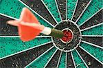Darts board with single arrow in bullseye