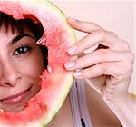 Woman eating a watermelon slice.