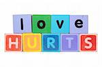 toy letters that spell love hurts against a white background with clipping path