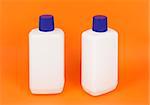 An image of nice white bottles on orange background