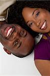Smiling black couple laying down