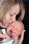 Beautiful mother holding her sleeping newborn girl