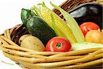 Fresh vegetables in a basket isolated on white background