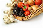 Fresh vegetables in a basket on white background