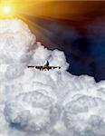 airplane flying into the clouds in a summer day