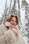 Portrait of frozen red-haired woman in winters day.