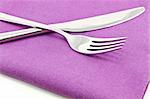 knife and fork on textile napkin