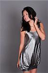 Slender young Singaporean Chinese woman in a silver dress