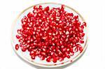 ripe pomegranate on plate on white background