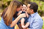 Happy Mixed Race Parents Playing with Their Giggling Son.