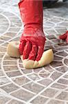 Close up of construction worker installing decorative tiles