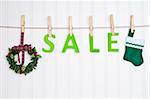 SALE on a Clothesline with a Wreath and Stocking.  Holiday Concept.