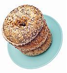 Everything Bagels Stacked on a Blue Plate.  Isolated on White with a Clipping Path.